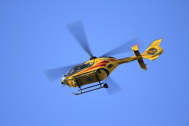 Yellow helicopter with blue sky as background